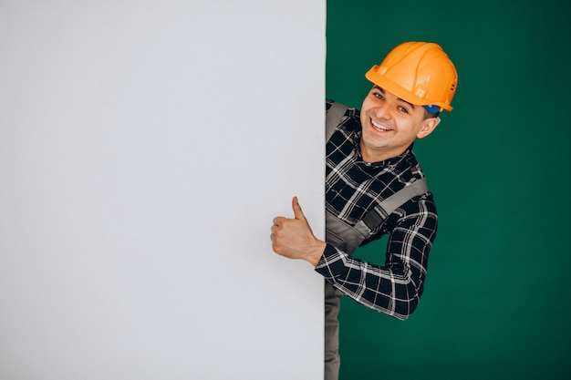 Man worker in hard hat isolated on green wall