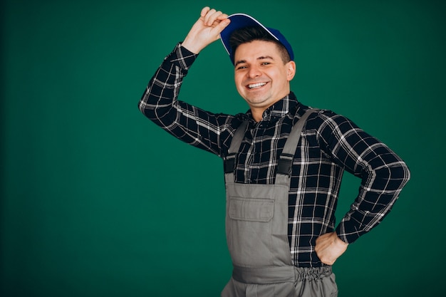 Man worker in hat isolated on green wall