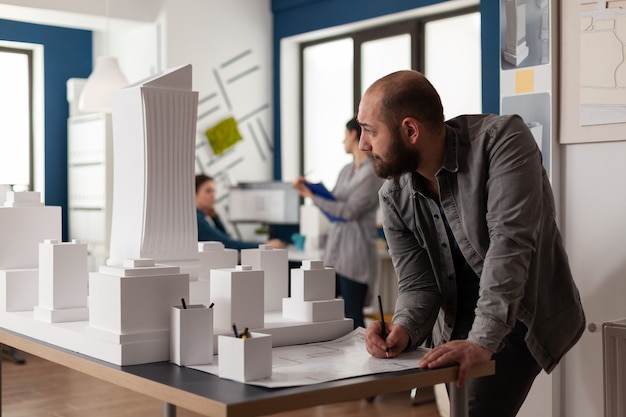 Man working on architectural design at office