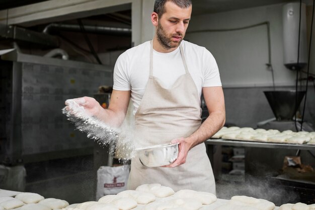 Free photo man working in a bread bakery