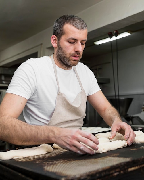 Free photo man working in a bread bakery