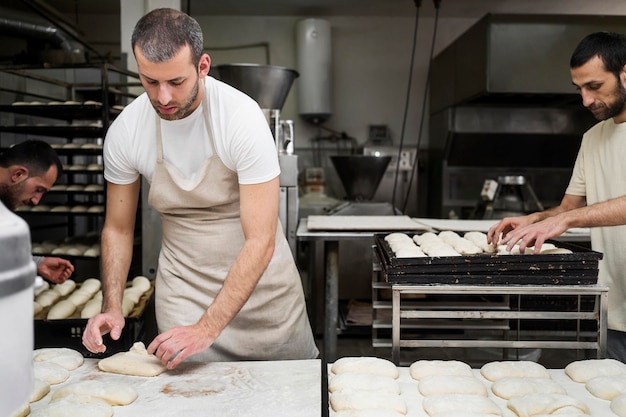 Free photo man working in a bread bakery