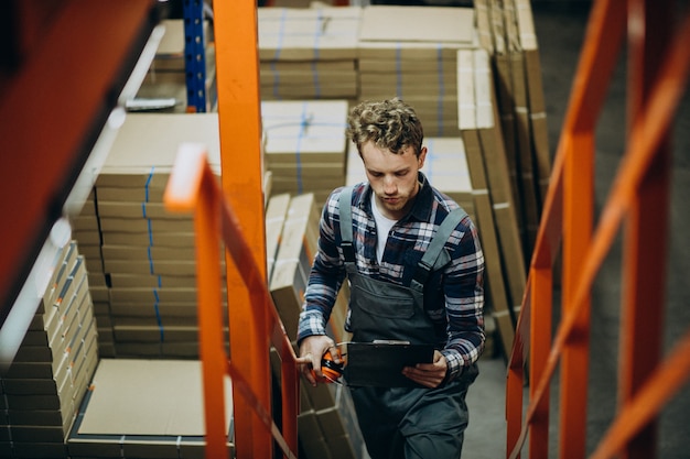 Free photo man working at a carboard factory