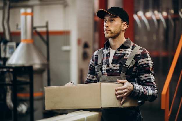 Free photo man working at a carboard factory