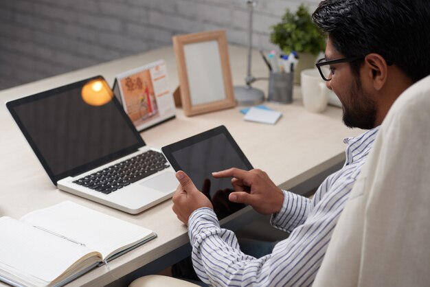 Man working on digital tablet