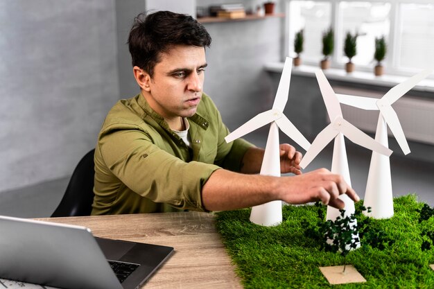 Man working on an eco-friendly wind power project with wind turbines