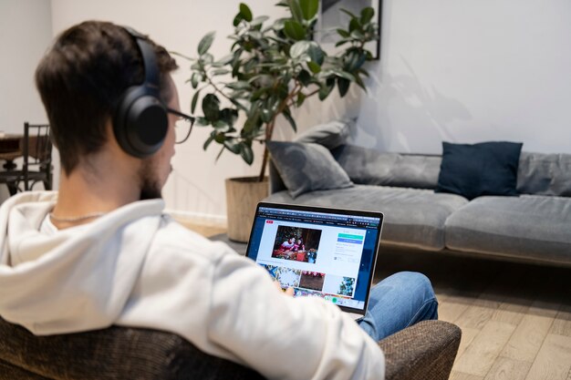 Free photo man working from home while sitting on armchair