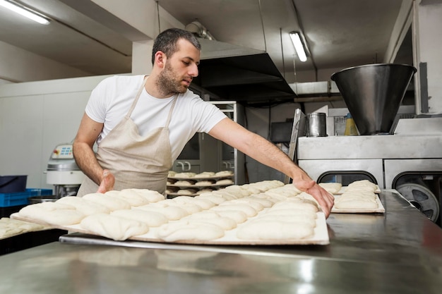 Man working hard at a bakery