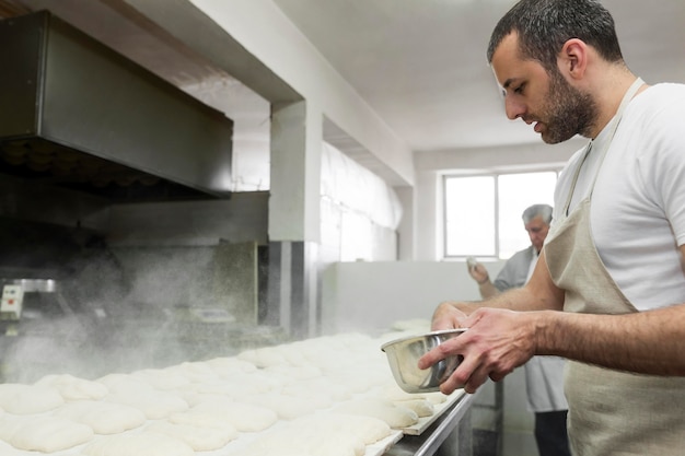 Man working hard at a bakery