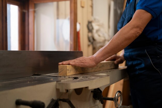 Man working in his wood shop with tools and equipment