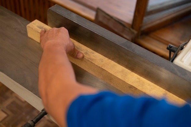 Free photo man working in his wood shop with tools and equipment