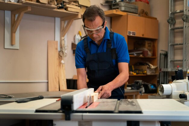 Man working in his wood shop with tools and equipment