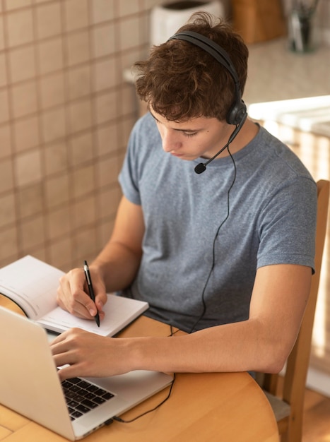 Man working in the kitchen at home during quarantine with laptop