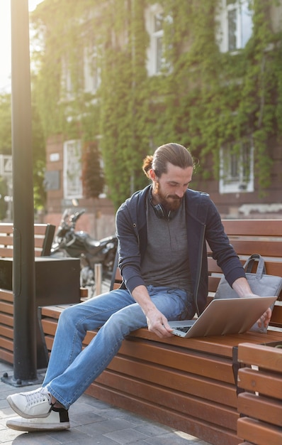 Man working on laptop outdoors in the city