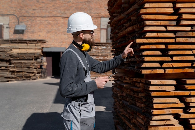 Free photo man working in a mdf boards warehouse