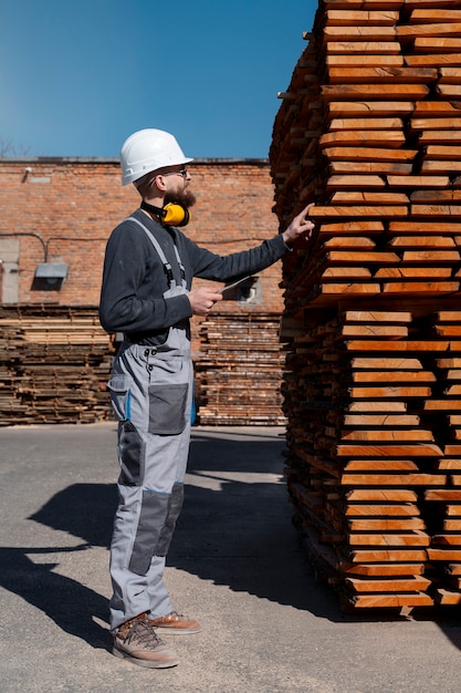 Foto gratuita uomo che lavora in un magazzino di pannelli mdf