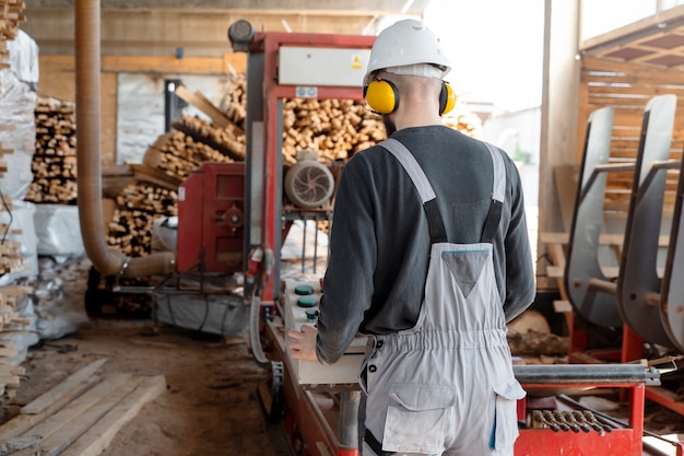 Free photo man working in a mdf boards warehouse