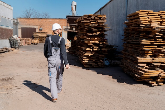 Free photo man working in a mdf boards warehouse