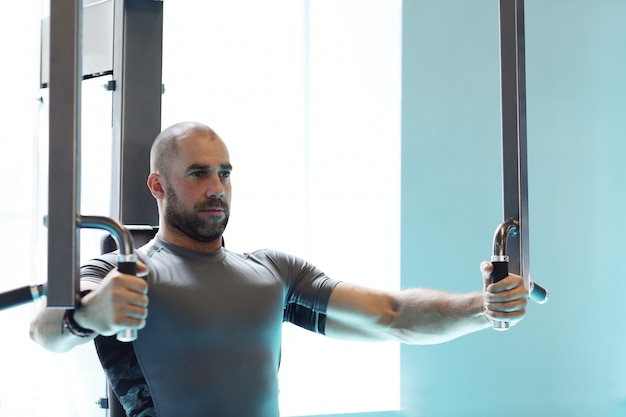 Free photo man working out in gym