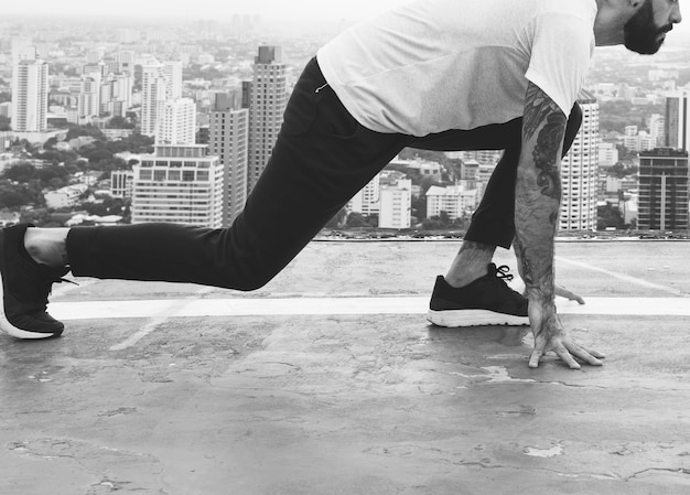 Free photo man working out on the rooftop