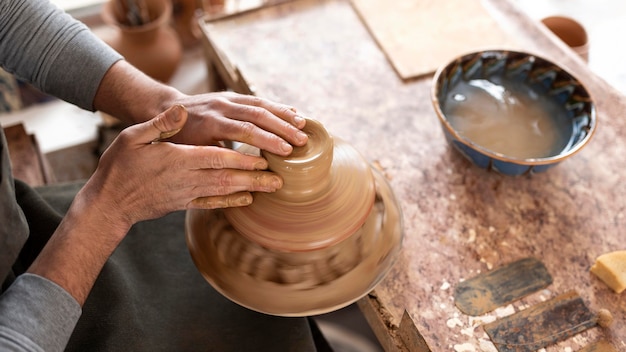 Free photo man working in pottery workshop