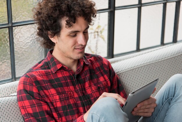 Foto gratuita uomo che lavora su tablet a casa