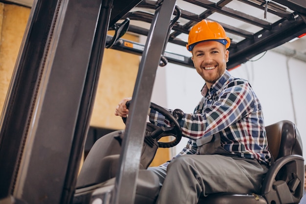 Free photo man working at warehouse and driving forklift