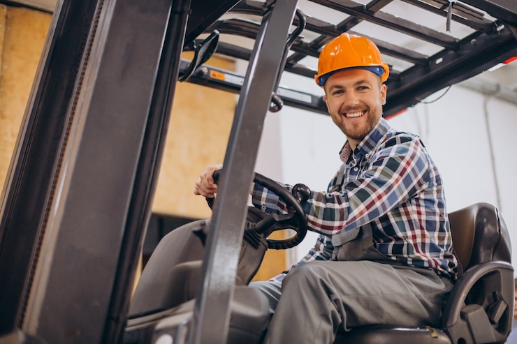 Free Photo man working at warehouse and driving forklift