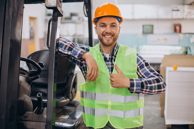 Man working at warehouse and driving forklift