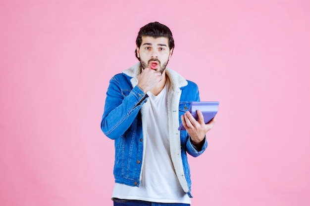 Man working with calculator and looks confused