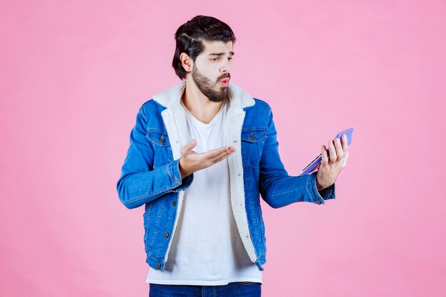 Man working with calculator and looks confused