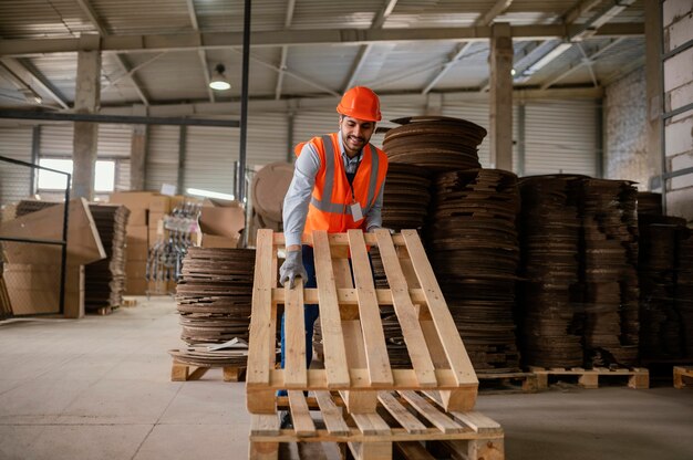 Man working with heavy wooden materials