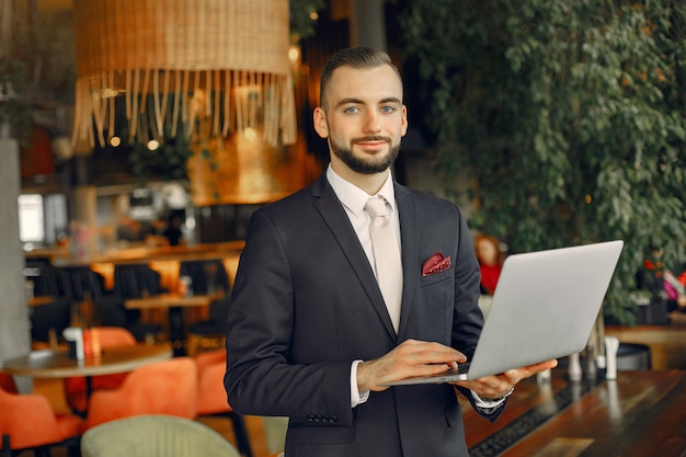 Free photo man working with a laptop at the table