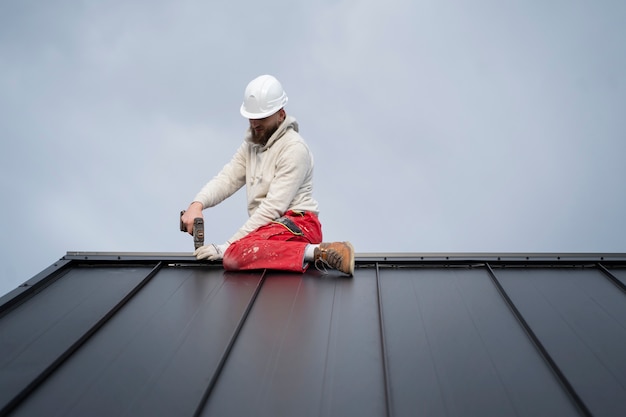 Free photo man working with protection helmet full shot