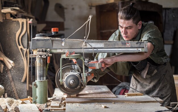 Man working with wooden product on the machine