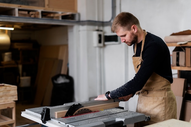 Free photo man working in a wood engraving workshop