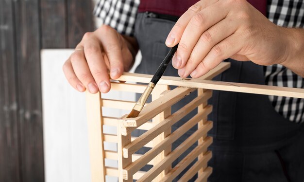 Man working on wood object close-up