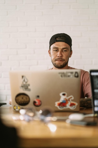 Free photo a man works at a computer in a coworking space. remote work, workspace.