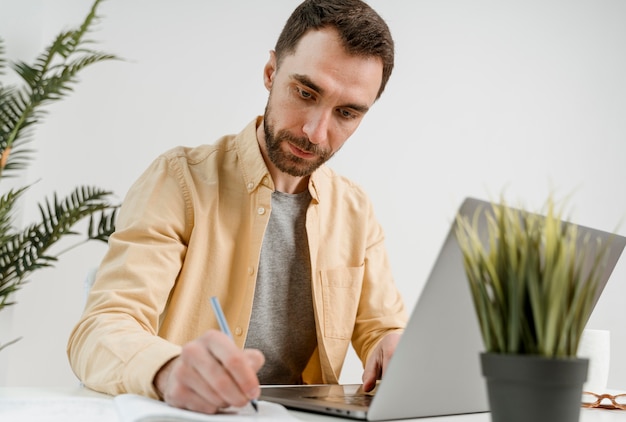 Man writing from video call class