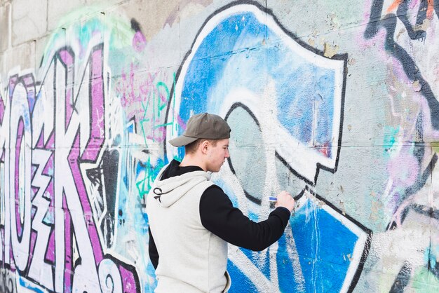 Man writing graffiti with marker