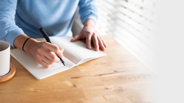 Free photo man writing in a journal while at home in the new normal