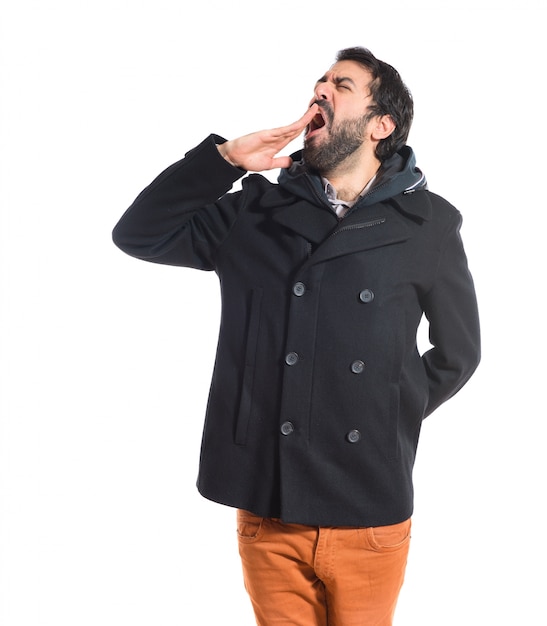 Man yawning over white background