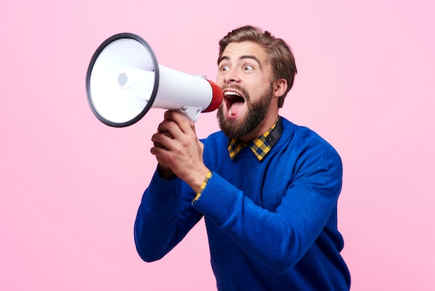 Free photo man yelling into a megaphone