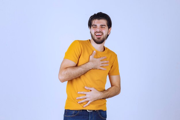 Man in yellow shirt giving seductive and appealing poses.