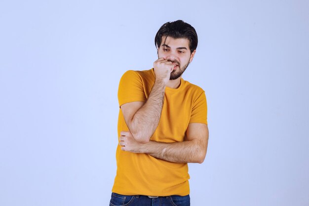 Man in yellow shirt giving seductive and appealing poses. 