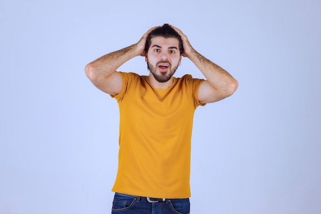 Man in yellow shirt giving seductive and appealing poses. 