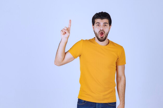 Man in yellow shirt looks scared and thrilled.