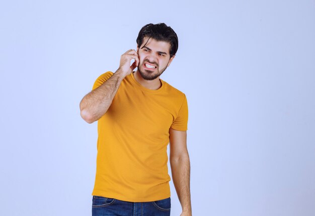 Man in yellow shirt looks scared and thrilled