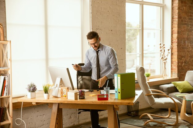 Management. A young businessman moving in the office