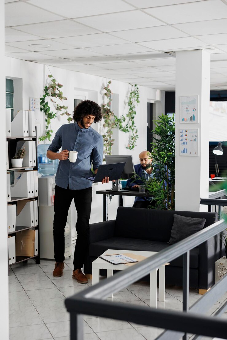 Free Photo manager working at financial analysis while standing with laptop